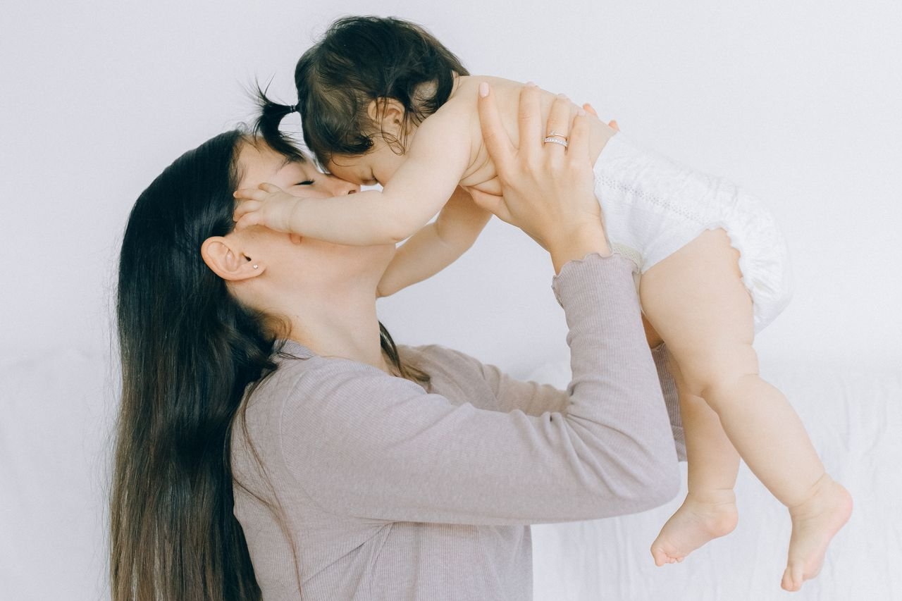 A tender moment between a mother and her baby, embracing love and care.